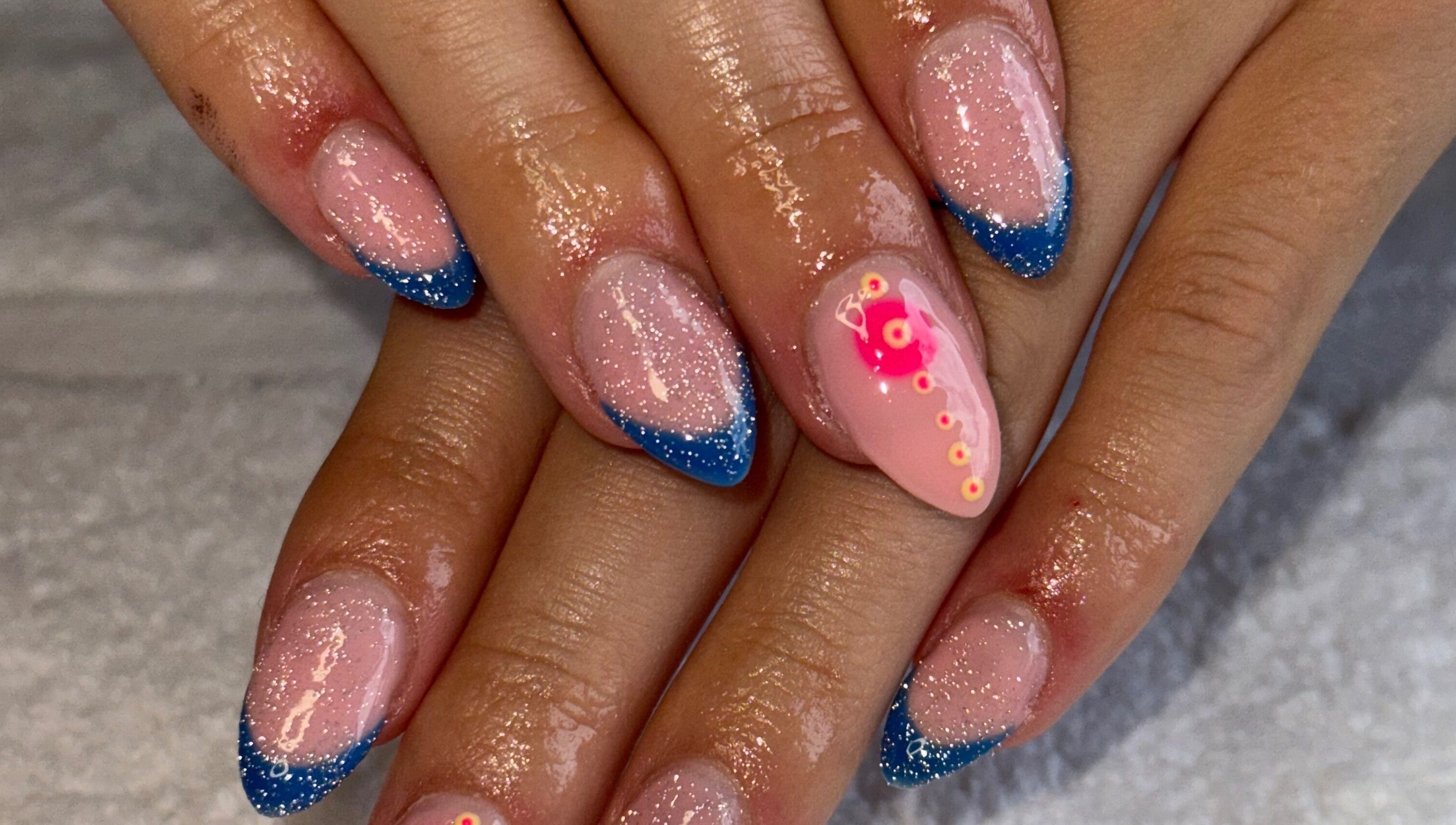 Sparkling nails with blue tips and pink accents at Nails by Nell, Hawthorn, England, GB.