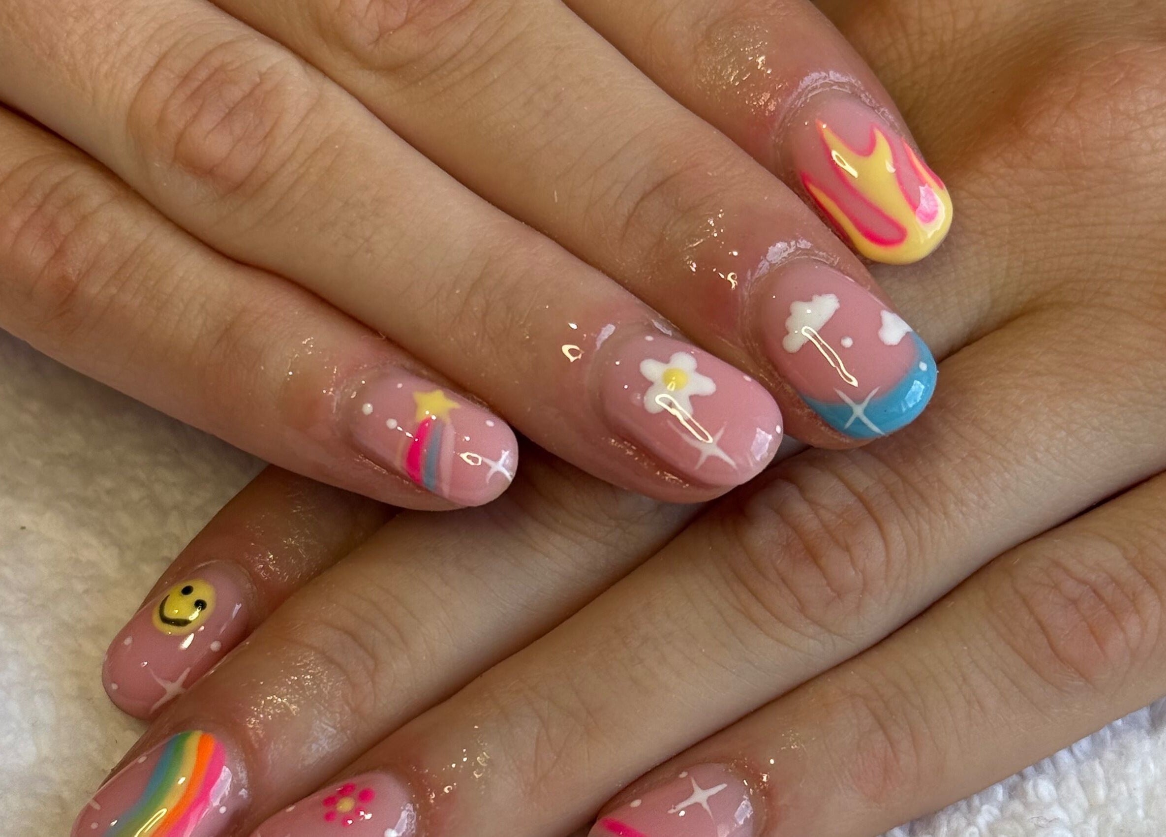 Colorful nail art with rainbows and stars at Nails by Nell, Hawthorn, England, GB.