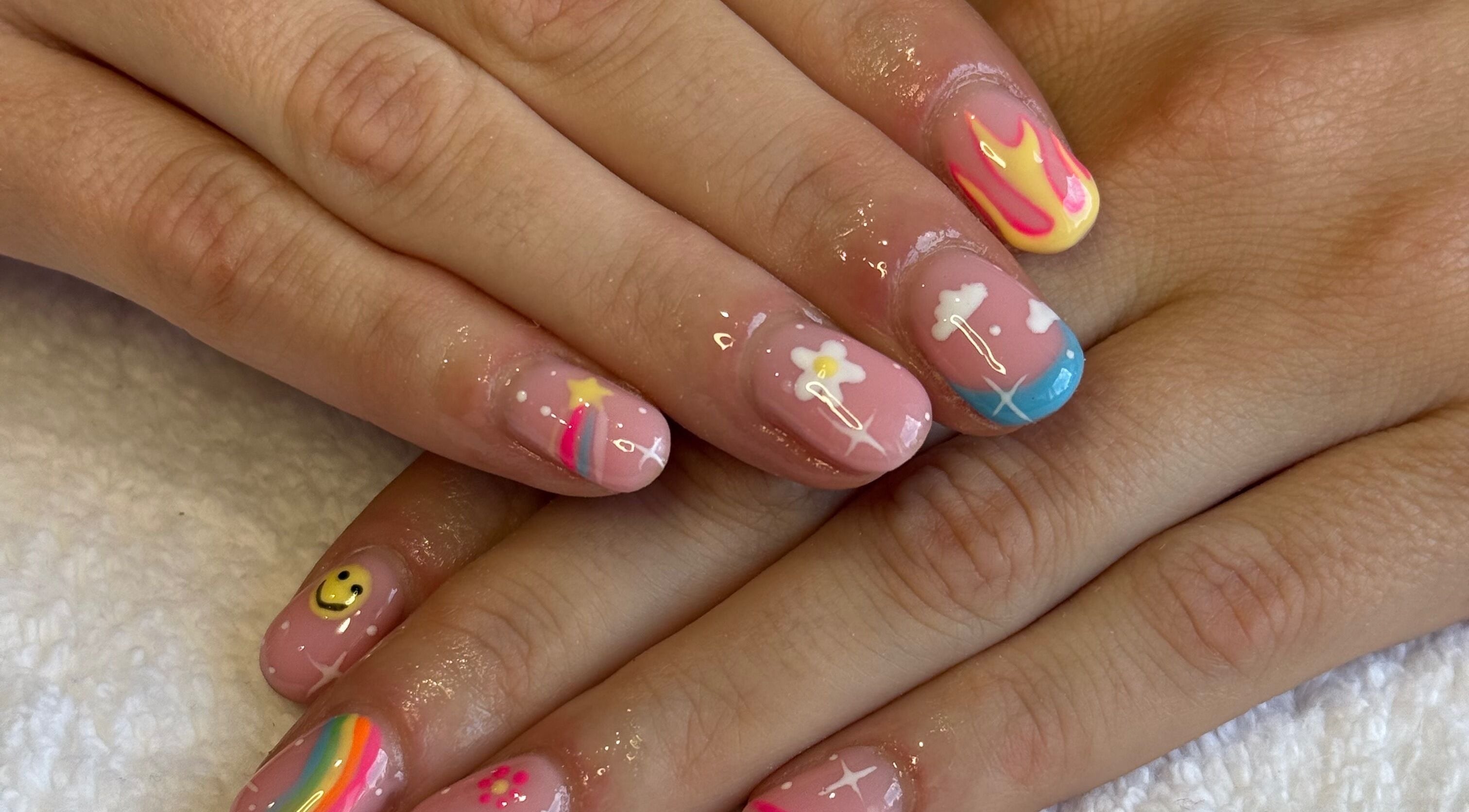 Colorful nail art with rainbows and stars at Nails by Nell, Hawthorn, England, GB.