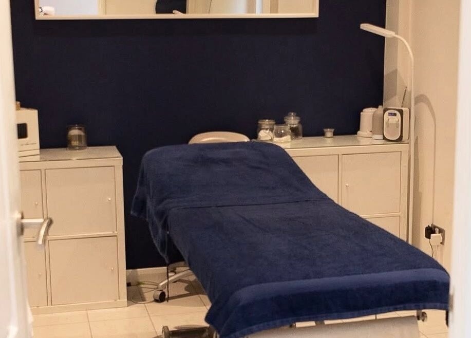 Cozy treatment room at The Secret Salon, West Malling, England, GB. Blue decor with white cabinets.