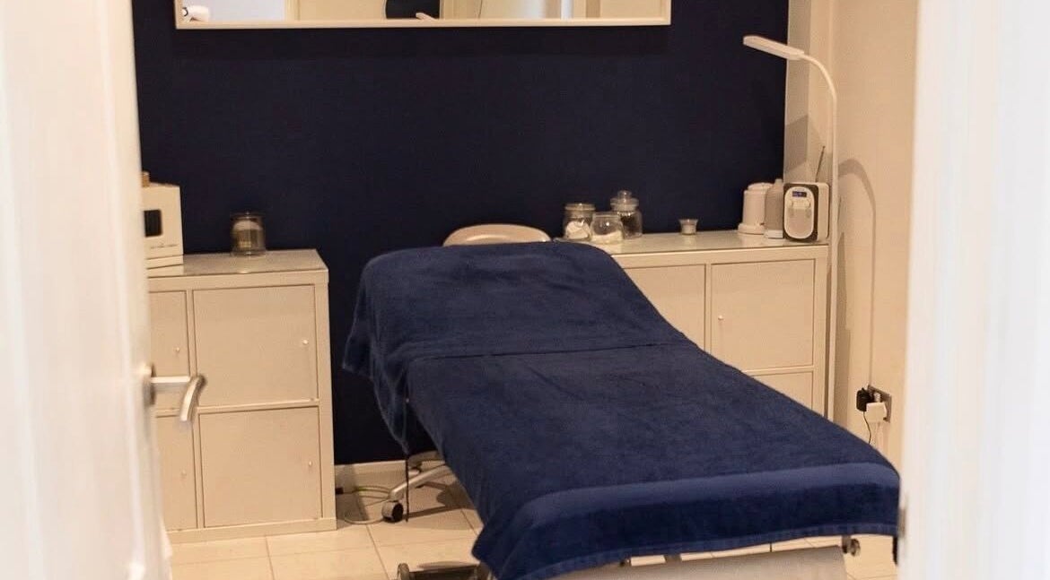 Cozy treatment room at The Secret Salon, West Malling, England, GB. Blue decor with white cabinets.