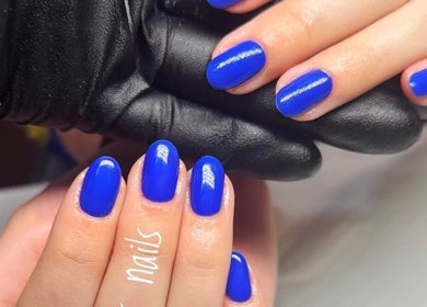 Bright blue manicured nails at Nails by Mariya, London, England, GB.