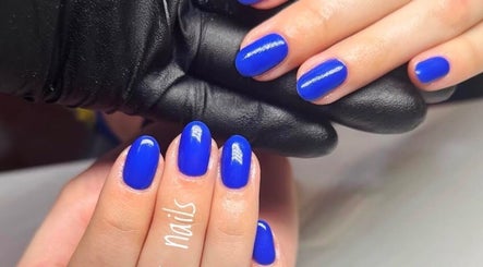 Bright blue manicured nails at Nails by Mariya, London, England, GB.