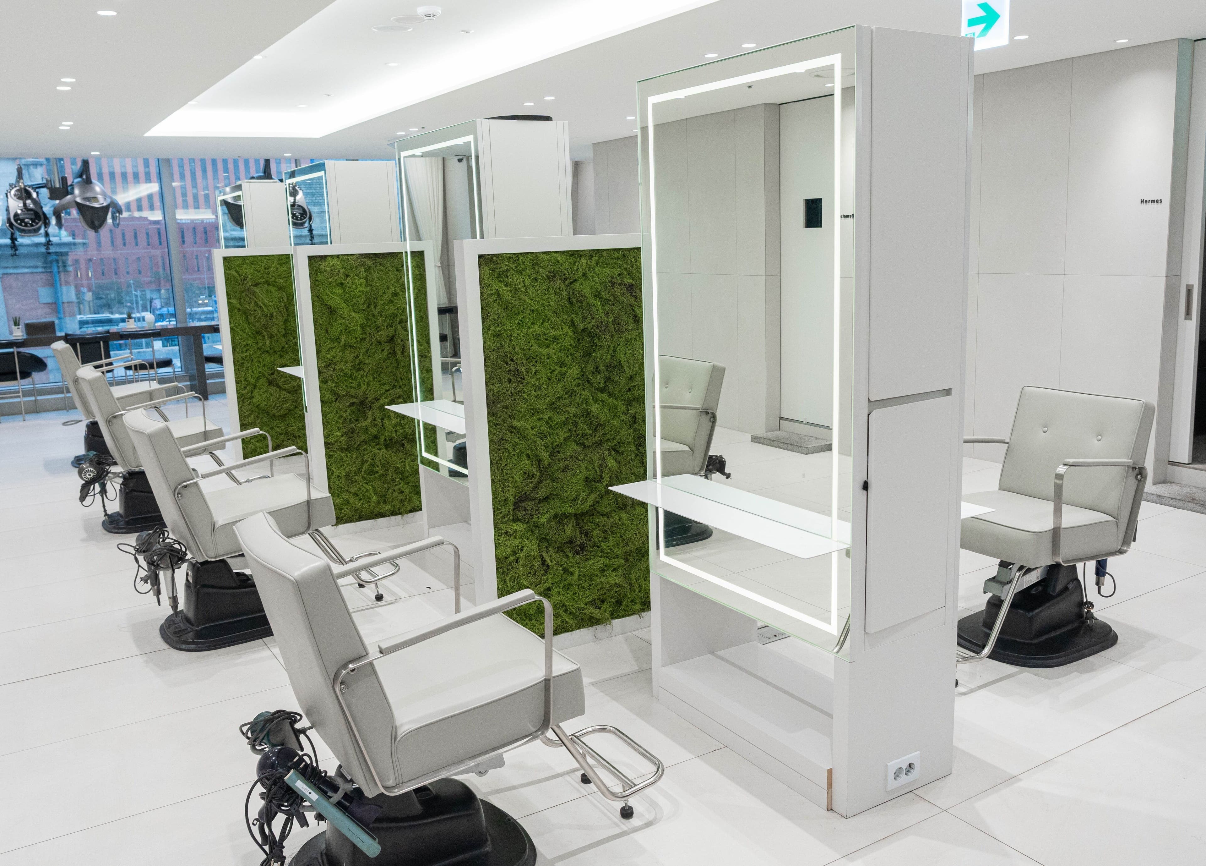 Modern salon chairs at 준오헤어 가든서울역점, Seoul with natural green decor, 서울특별시, 서울특별시, KR.