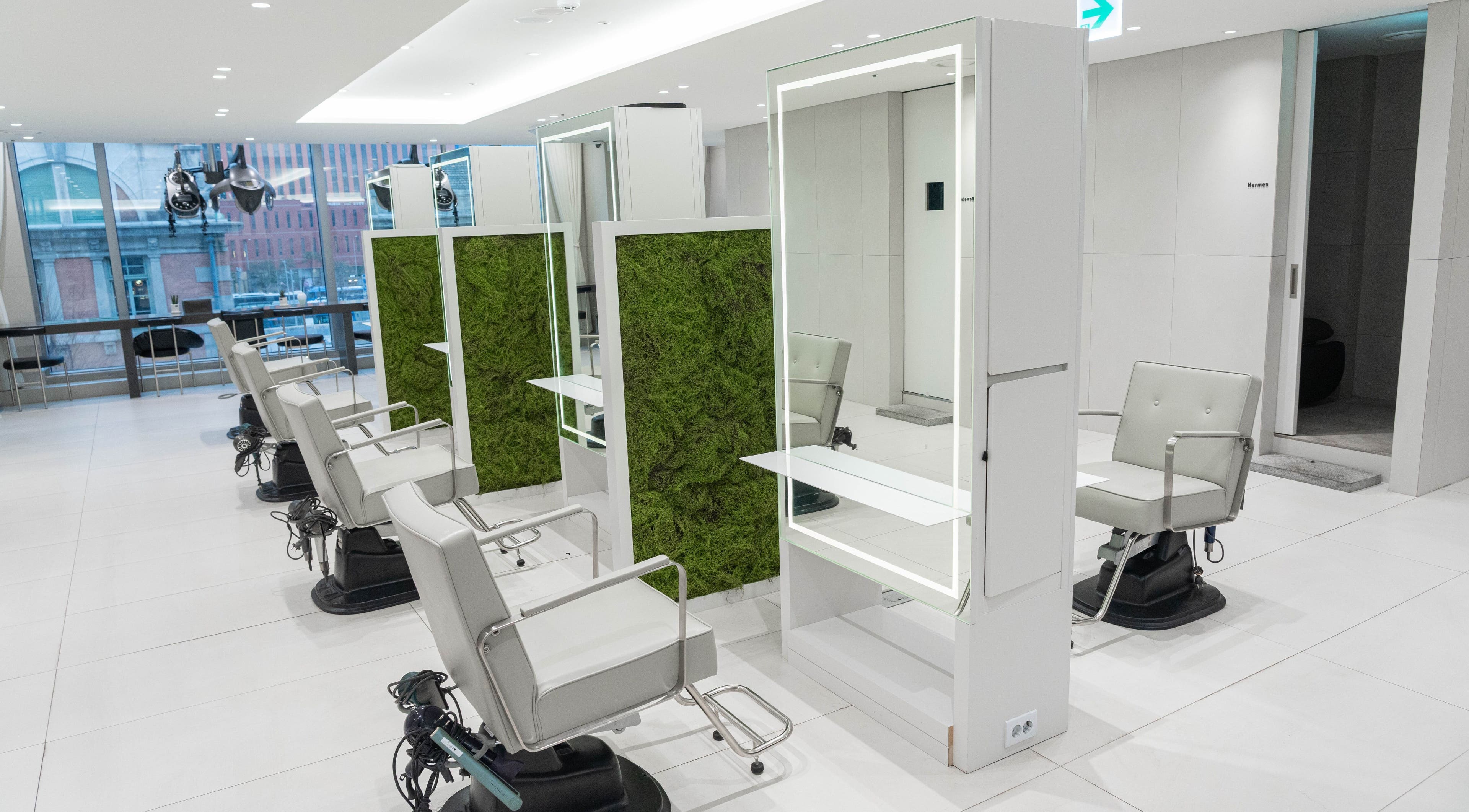 Modern salon chairs at 준오헤어 가든서울역점, Seoul with natural green decor, 서울특별시, 서울특별시, KR.