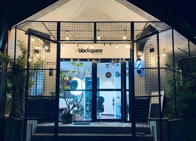 Black Space Barbershop's cozy entrance illuminated at night in Biñan, Calabarzon, PH.