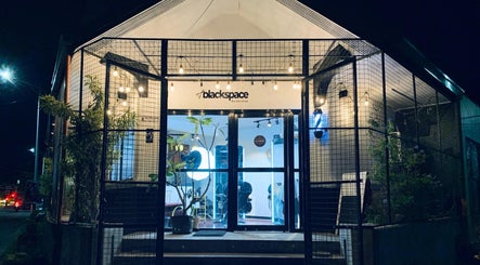Black Space Barbershop's cozy entrance illuminated at night in Biñan, Calabarzon, PH.