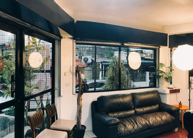 Inviting lounge area in Black Space Barbershop, Biñan, Calabarzon, PH, featuring a leather sofa and stylish decor.