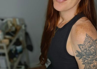 Person with intricate rose tattoo at Kelly's Beauty & Holistic Therapies, Eastbourne, England, GB.