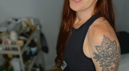 Person with intricate rose tattoo at Kelly's Beauty & Holistic Therapies, Eastbourne, England, GB.