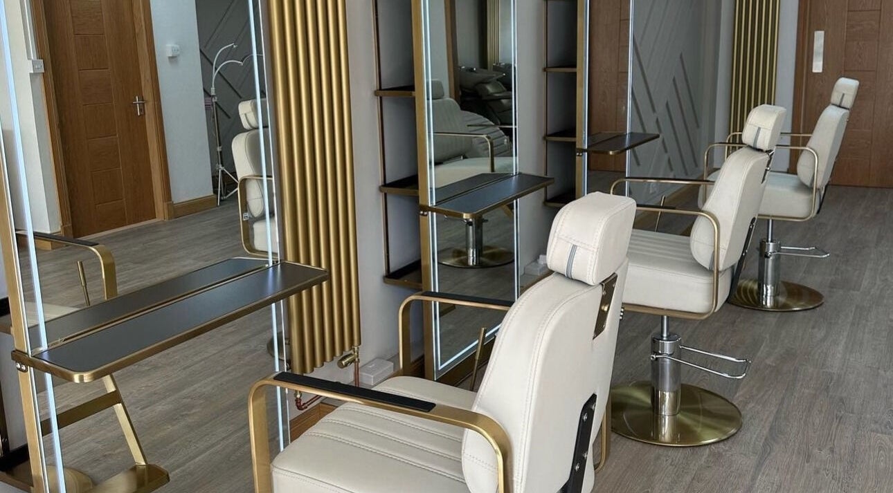 Modern salon interior at Iconic Beauty, Larbert, Scotland, GB, featuring sleek chairs and mirrors.
