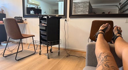 Client relaxing in stylish ZÜS salon, Ormeau, Queensland, AU with modern decor and service tools.