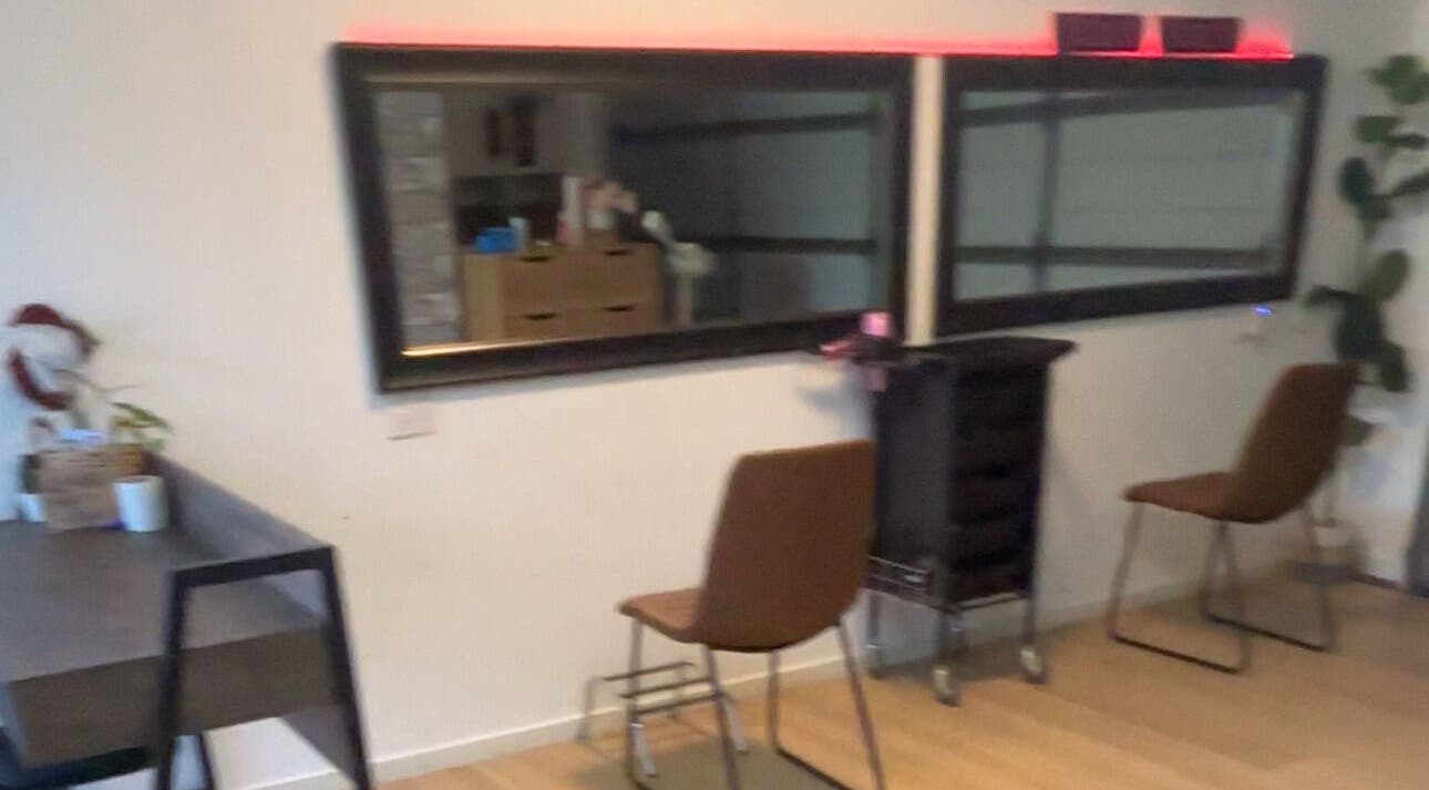 Elegant salon area at ZÜS, Ormeau, Queensland, AU with chic mirrors and modern seating.