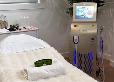 Palm Laser spa room in Holsworthy, New South Wales, AU featuring a laser machine and treatment bed.