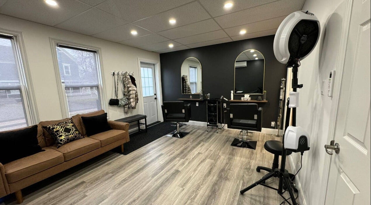 Modern beauty salon interior at Samira, Moncton, New Brunswick, CA featuring stylish furniture and mirrors.