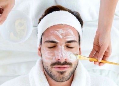 Man enjoys facial treatment at Royal Tree Beauty, Potchefstroom, North West, ZA. Relaxing skincare therapy.