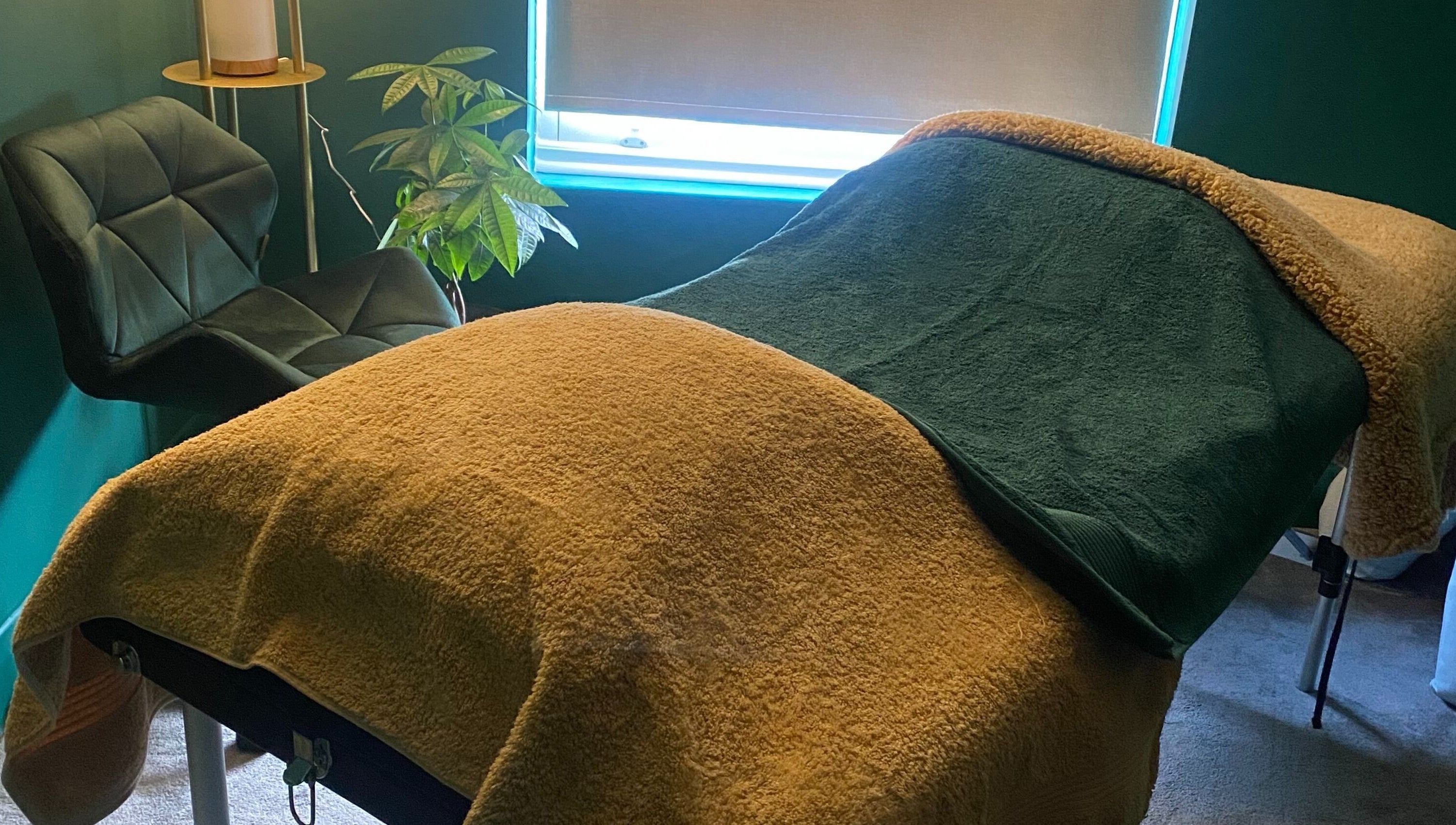 Cozy therapy room at Heeling Palms Reflexology & Holistic Health in Fareham, England, GB featuring a massage table.