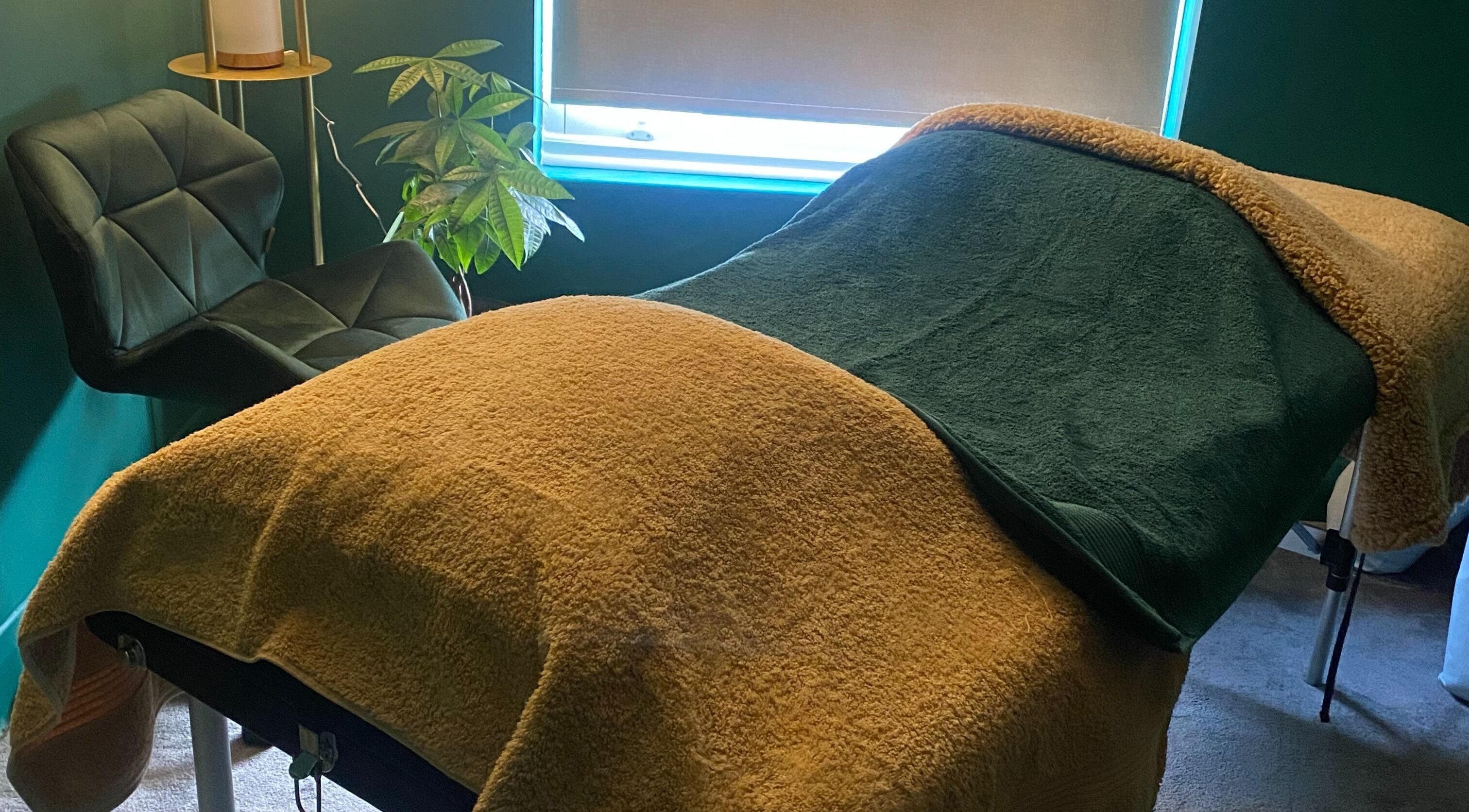 Cozy therapy room at Heeling Palms Reflexology & Holistic Health in Fareham, England, GB featuring a massage table.