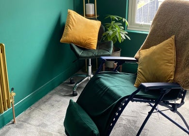 Relaxing room at Heeling Palms Reflexology & Holistic Health, Fareham, England, GB with plush chairs and green decor.