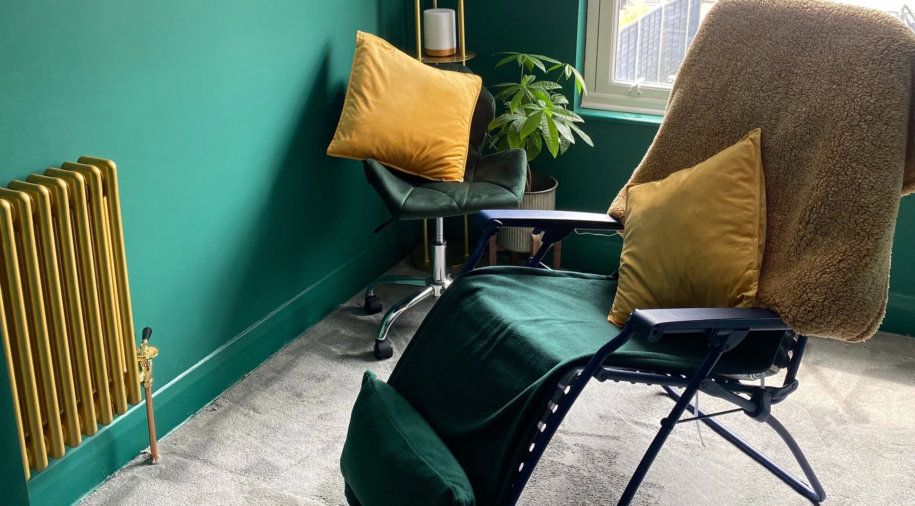 Relaxing room at Heeling Palms Reflexology & Holistic Health, Fareham, England, GB with plush chairs and green decor.