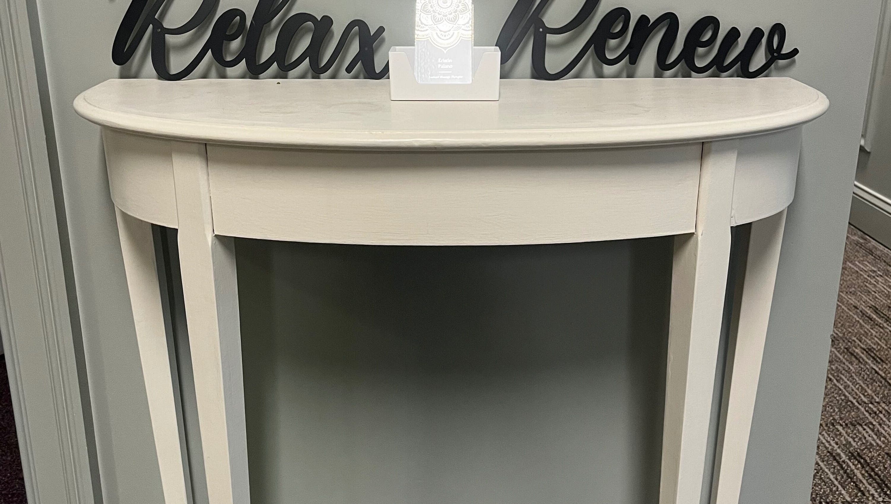 Elegant console at Kristin Palano in South Hadley, Massachusetts, US. Sign reads 'Relax Renew'.