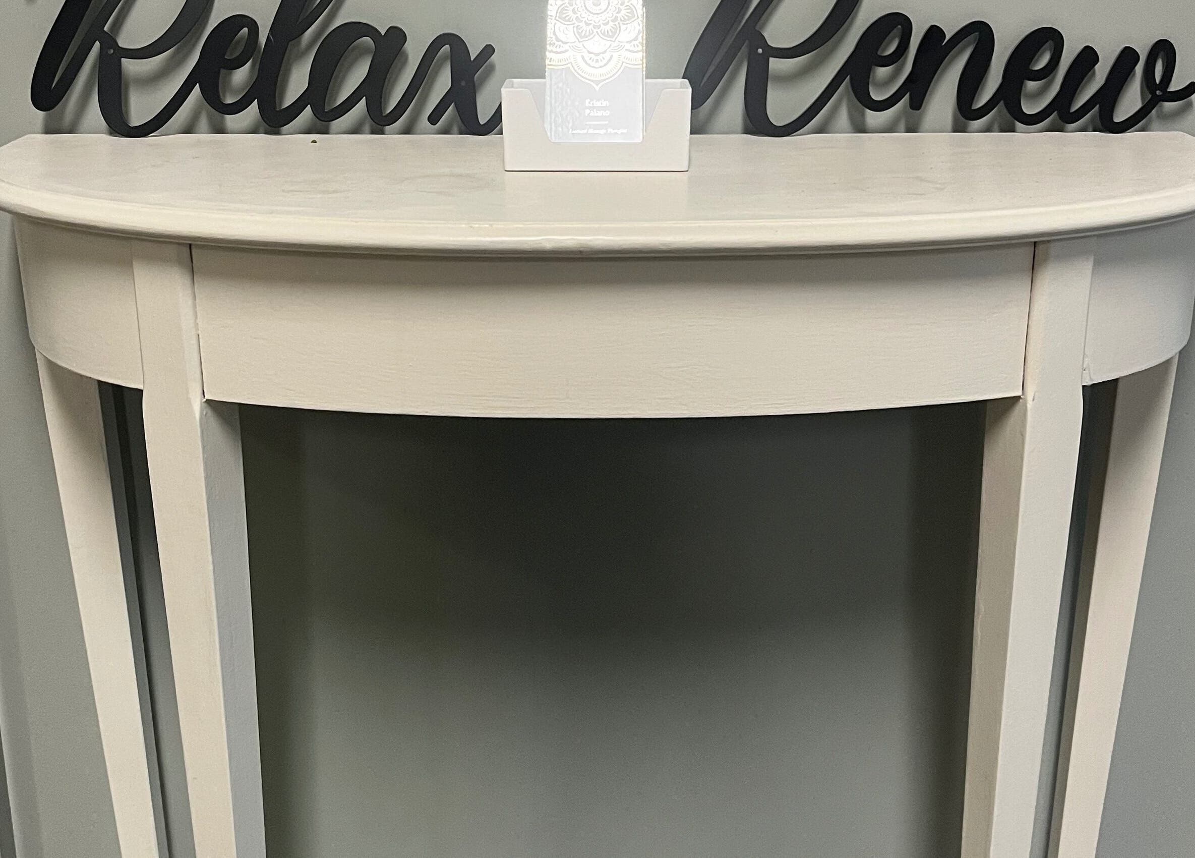 Elegant console at Kristin Palano in South Hadley, Massachusetts, US. Sign reads 'Relax Renew'.