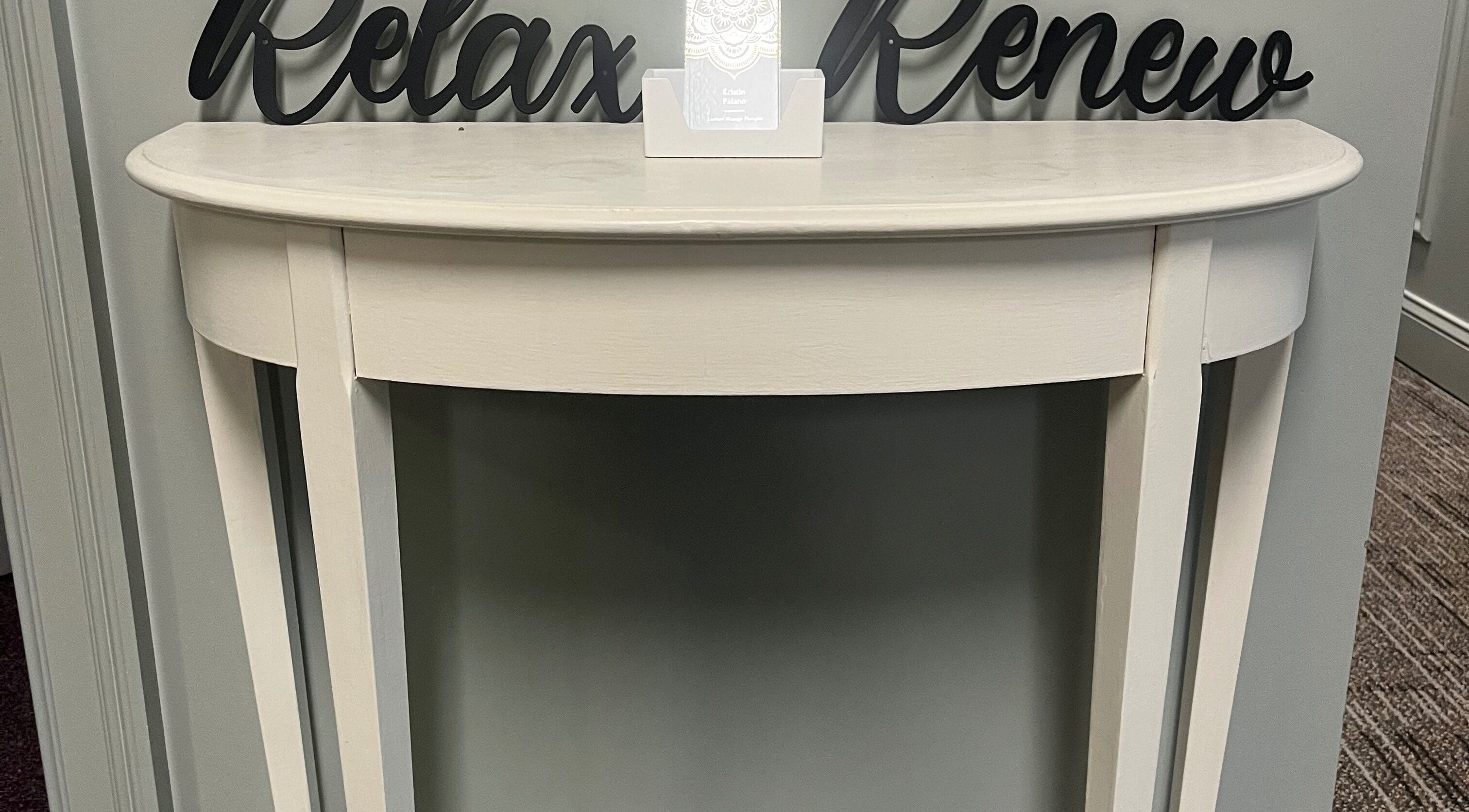 Elegant console at Kristin Palano in South Hadley, Massachusetts, US. Sign reads 'Relax Renew'.