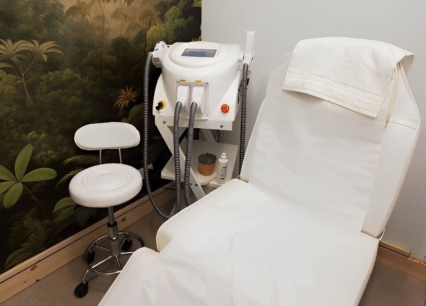 Relaxing treatment room at Miah’s Aesthetics, Eastbourne, England with chair and equipment for wellness care.