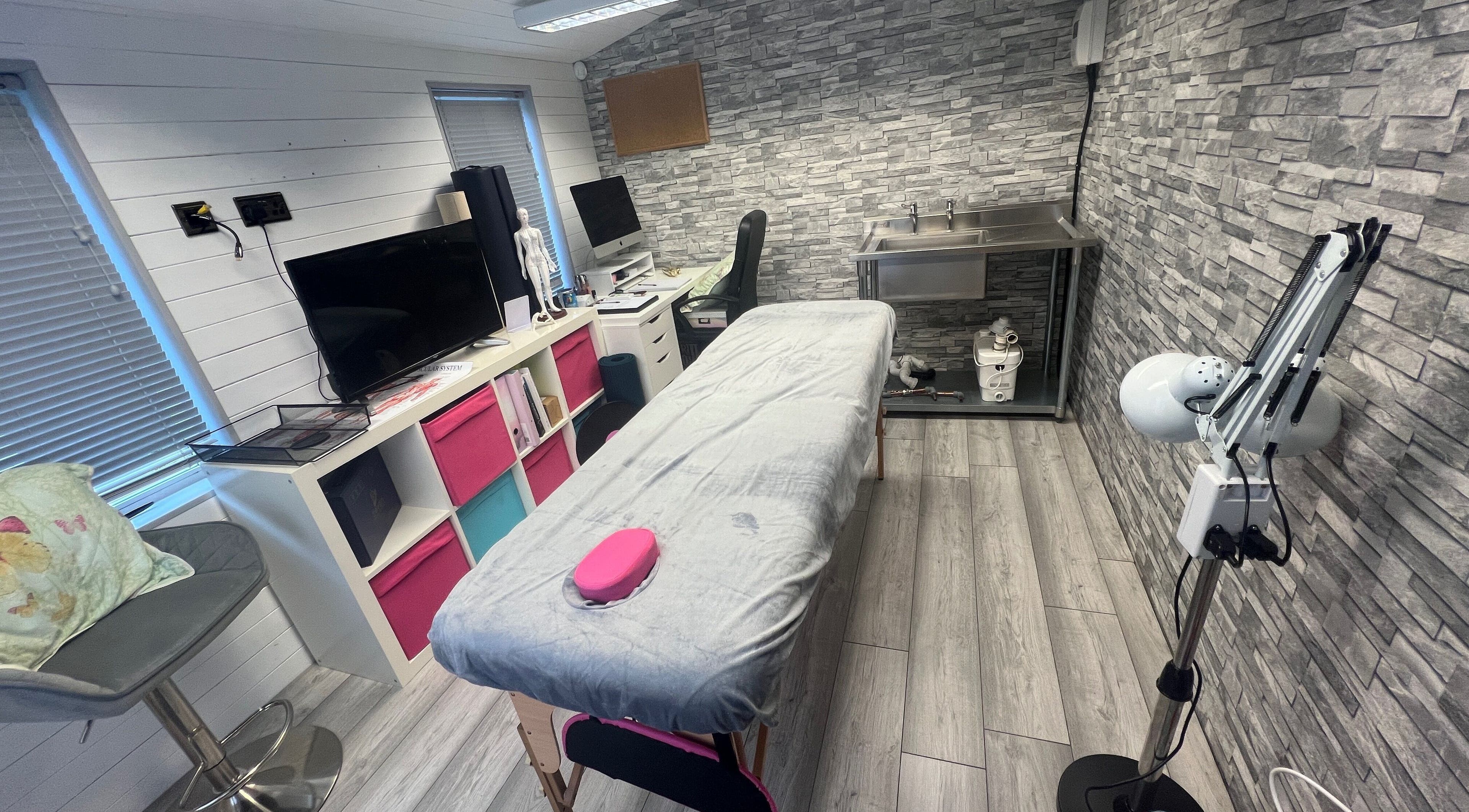 Cozy massage therapy room at Bone & Body Healing, Long Eaton, England, GB, featuring a cushioned table.