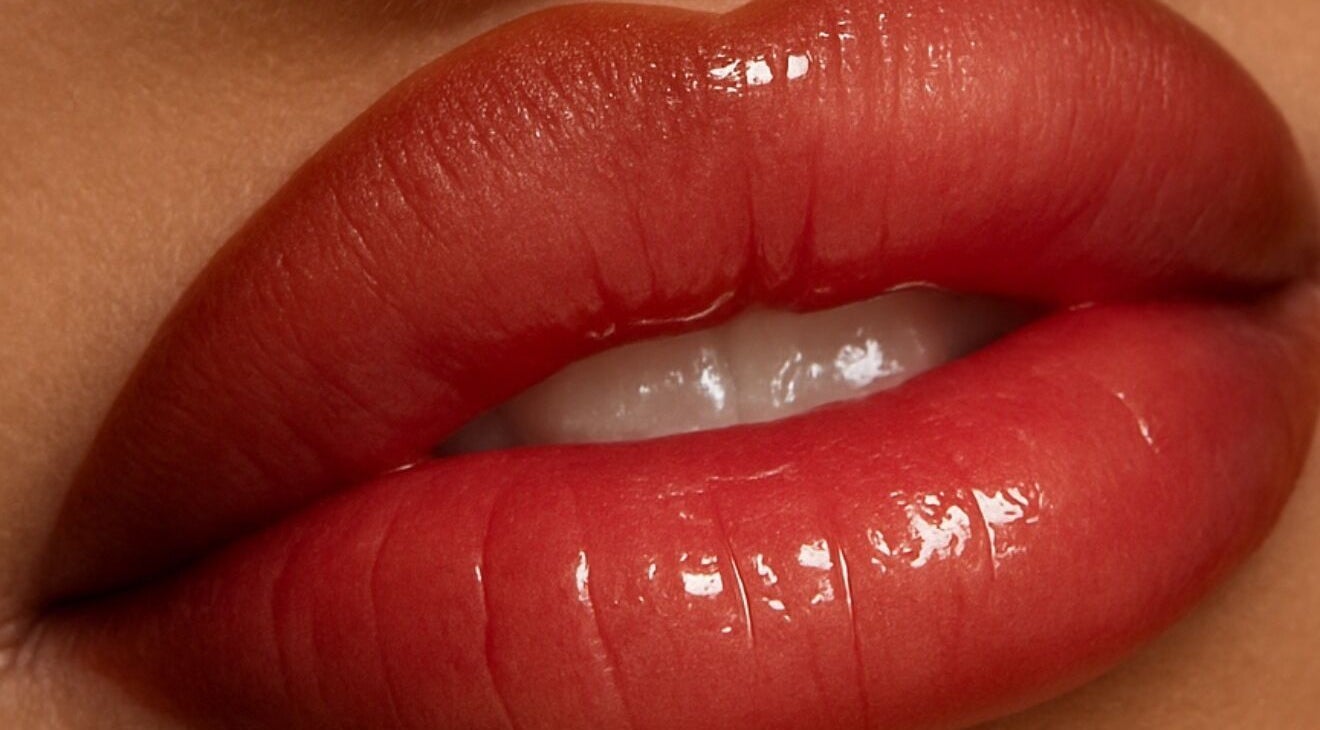 Vibrant red lips with gloss, showcasing beauty services at EnhancedbyMursal, Toronto, Ontario, CA.