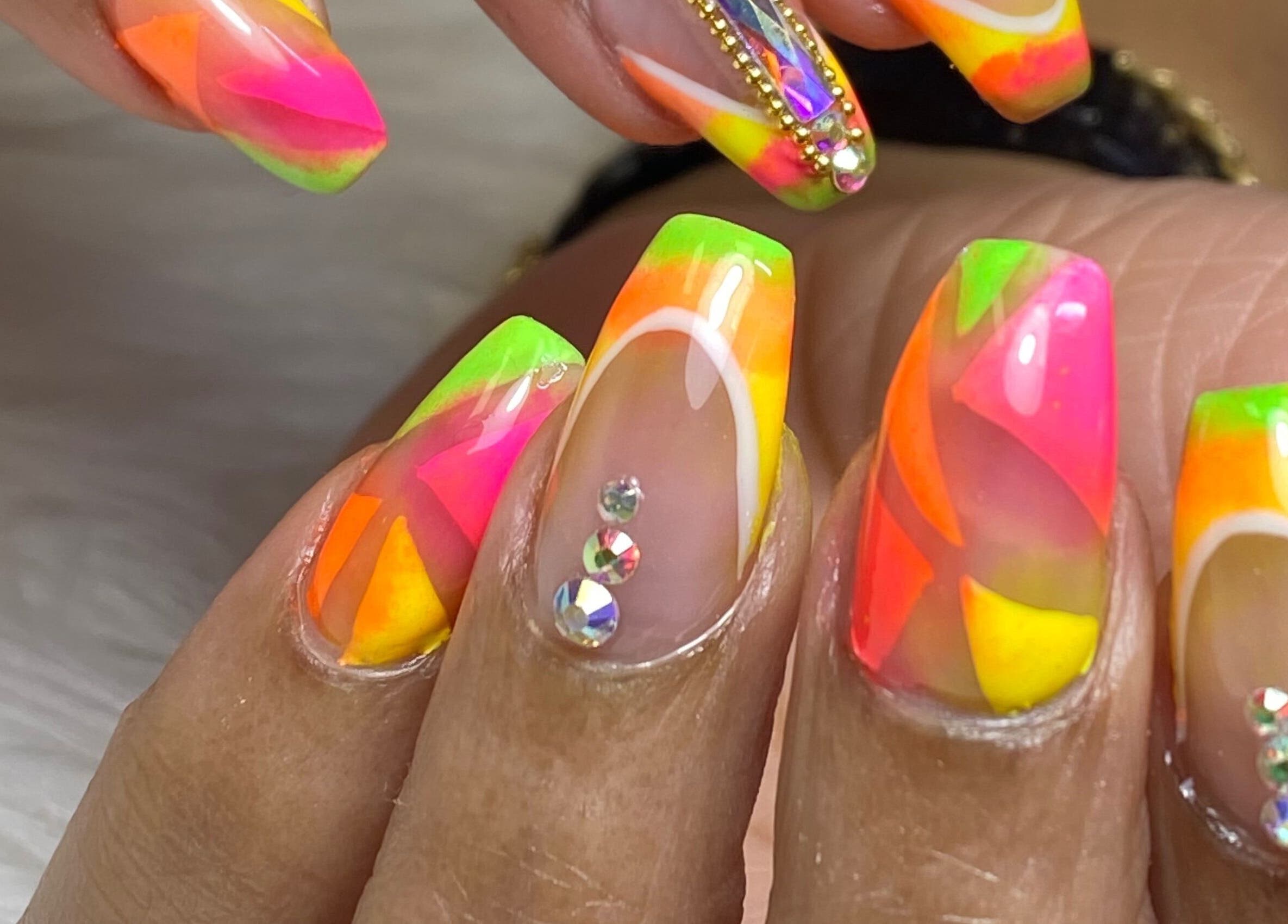 Bright neon nail art with rhinestones at Acacias Nails By JC, Toronto, Ontario, CA.
