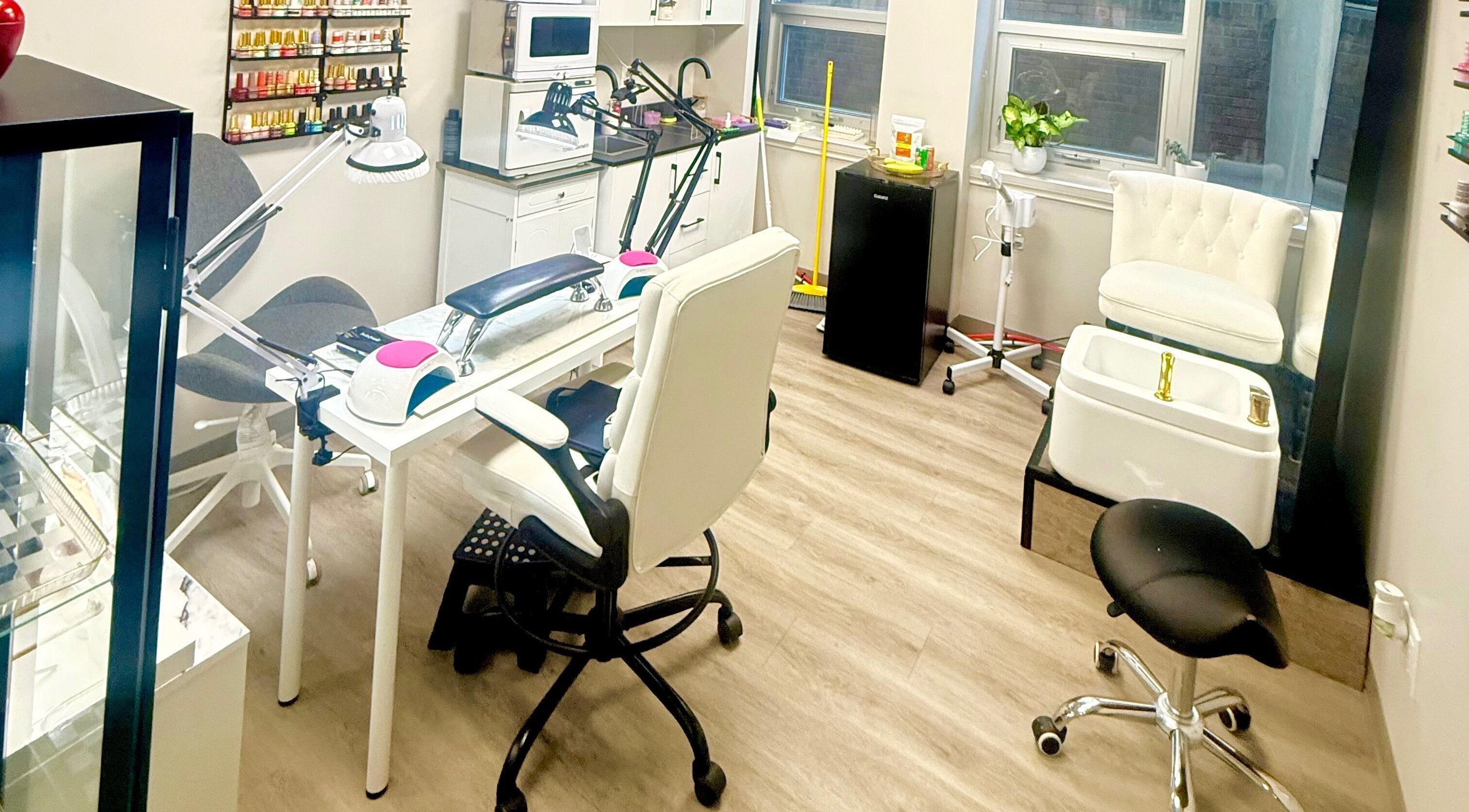Bright and modern nail salon interior at Acacias Nails By JC, Toronto, Ontario, CA, showcasing manicure and pedicure stations.