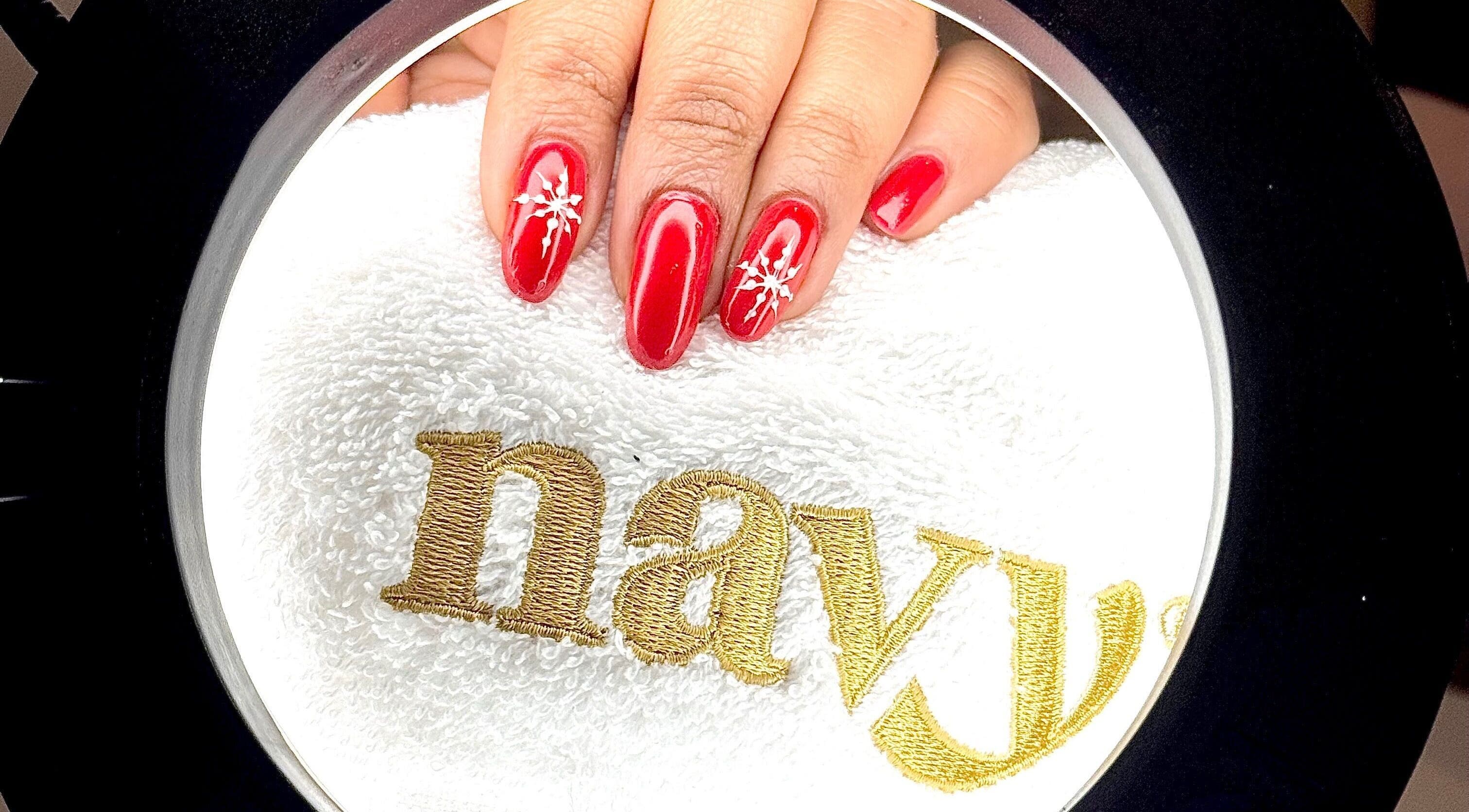 Red nails with snowflake art at Nails Etc By Pri, West Bridgford, England, GB.