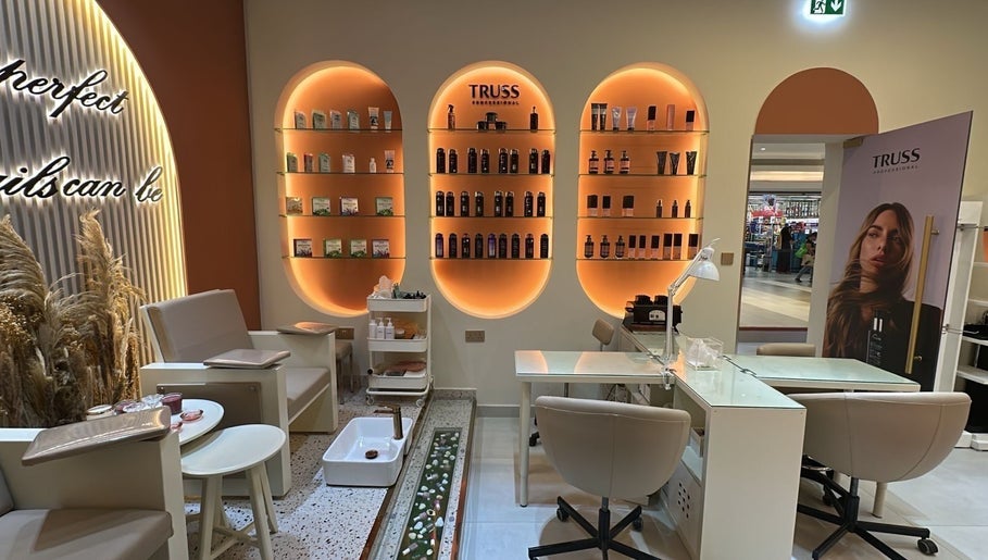 Interior of Flair Beauty Salon in دبي, دبي, AE with stylish shelving and cozy seating.