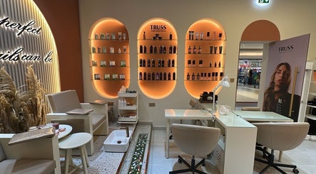 Interior of Flair Beauty Salon in دبي, دبي, AE with stylish shelving and cozy seating.