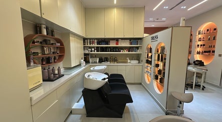 Modern interior of Flair Beauty Salon in دبي, دبي, AE with sleek shelves, chairs, and beauty products on display.