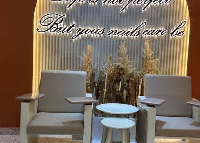 Elegant seating area at Flair Beauty Salon, Dubai, AE, with stylish armchairs and decorative plants.