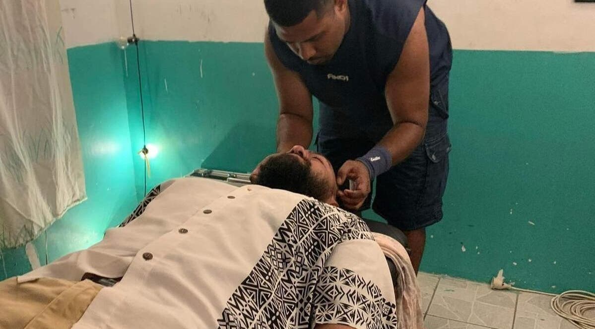 A massage therapist at Dynamic Massage & Adjustment in Suva, Central Division, FJ provides a relaxing neck massage.