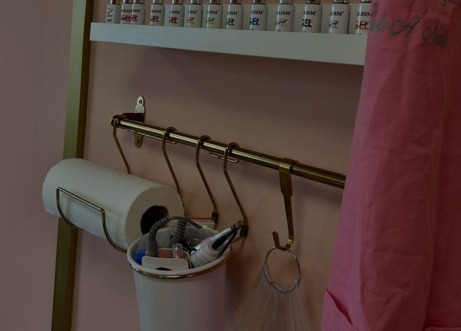 Nail care tools and a coat at Triple A Nails, Dumbarton, Scotland, GB showcasing the salon's tidy setup.