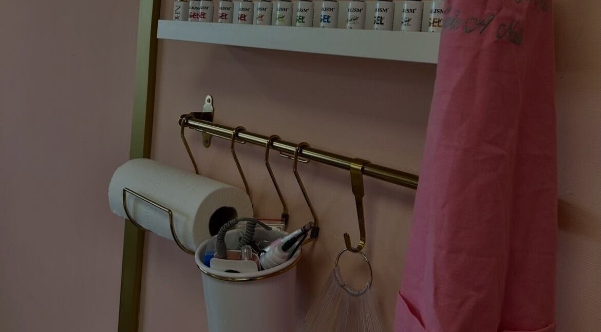 Nail care tools and a coat at Triple A Nails, Dumbarton, Scotland, GB showcasing the salon's tidy setup.