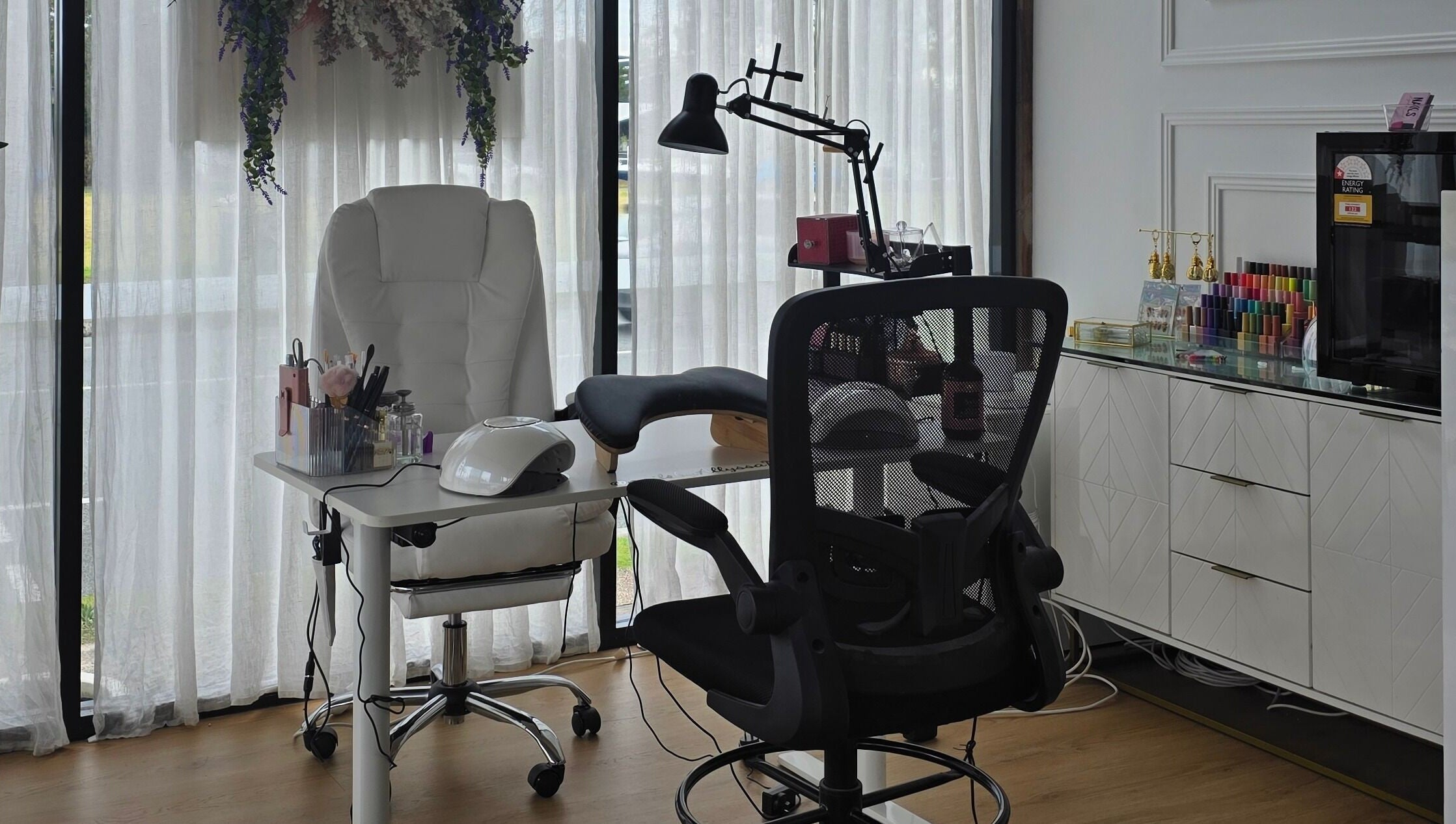 Elegant nail station at Nails by Allyssa Marie in Mooloolaba, Queensland, AU, with white chairs and equipment.