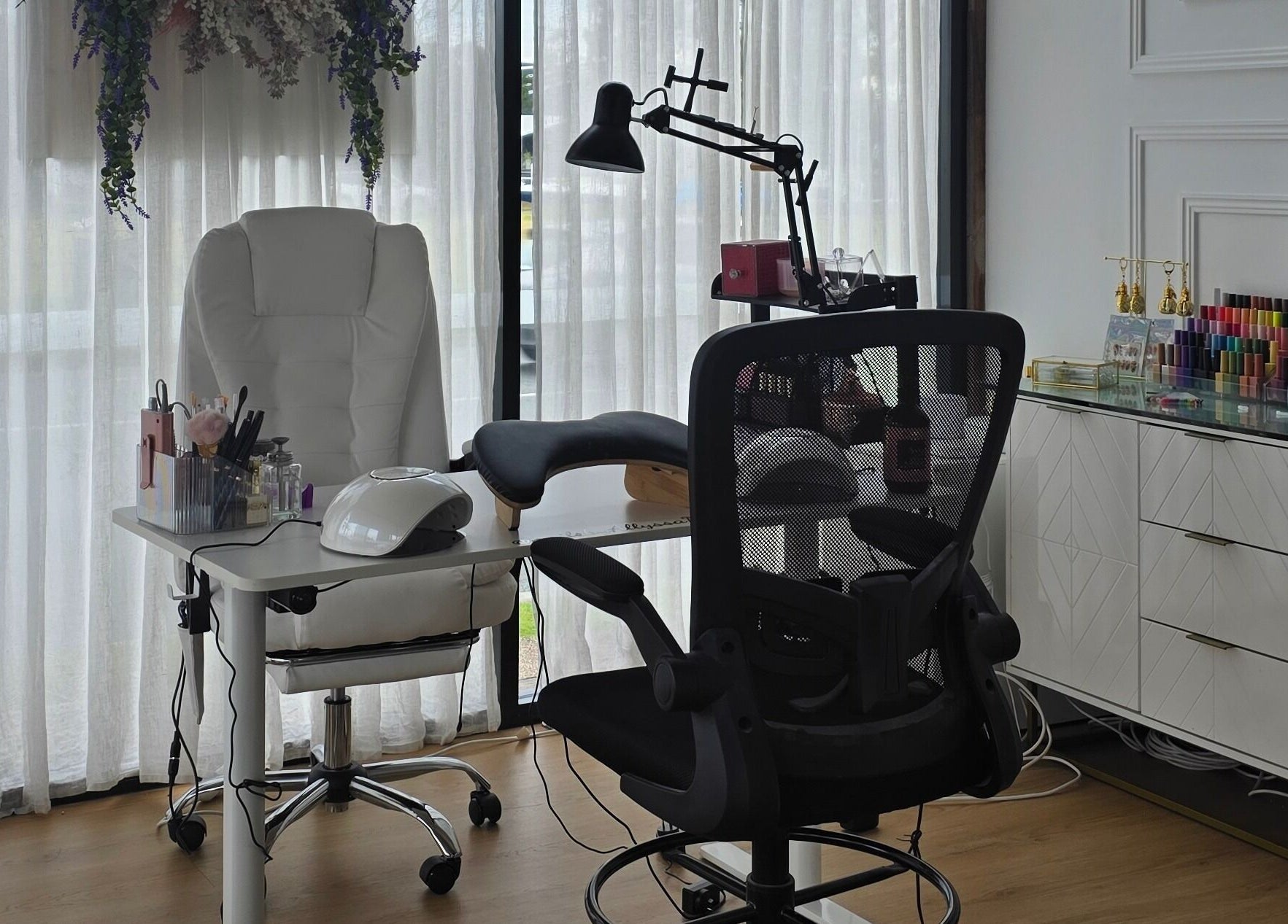 Elegant nail station at Nails by Allyssa Marie in Mooloolaba, Queensland, AU, with white chairs and equipment.