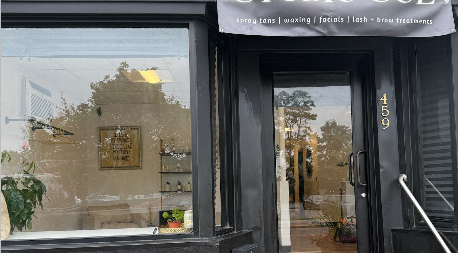Front view of Studio Sol, a chic beauty venue in Farmingdale, New York, US with stylish black exterior.