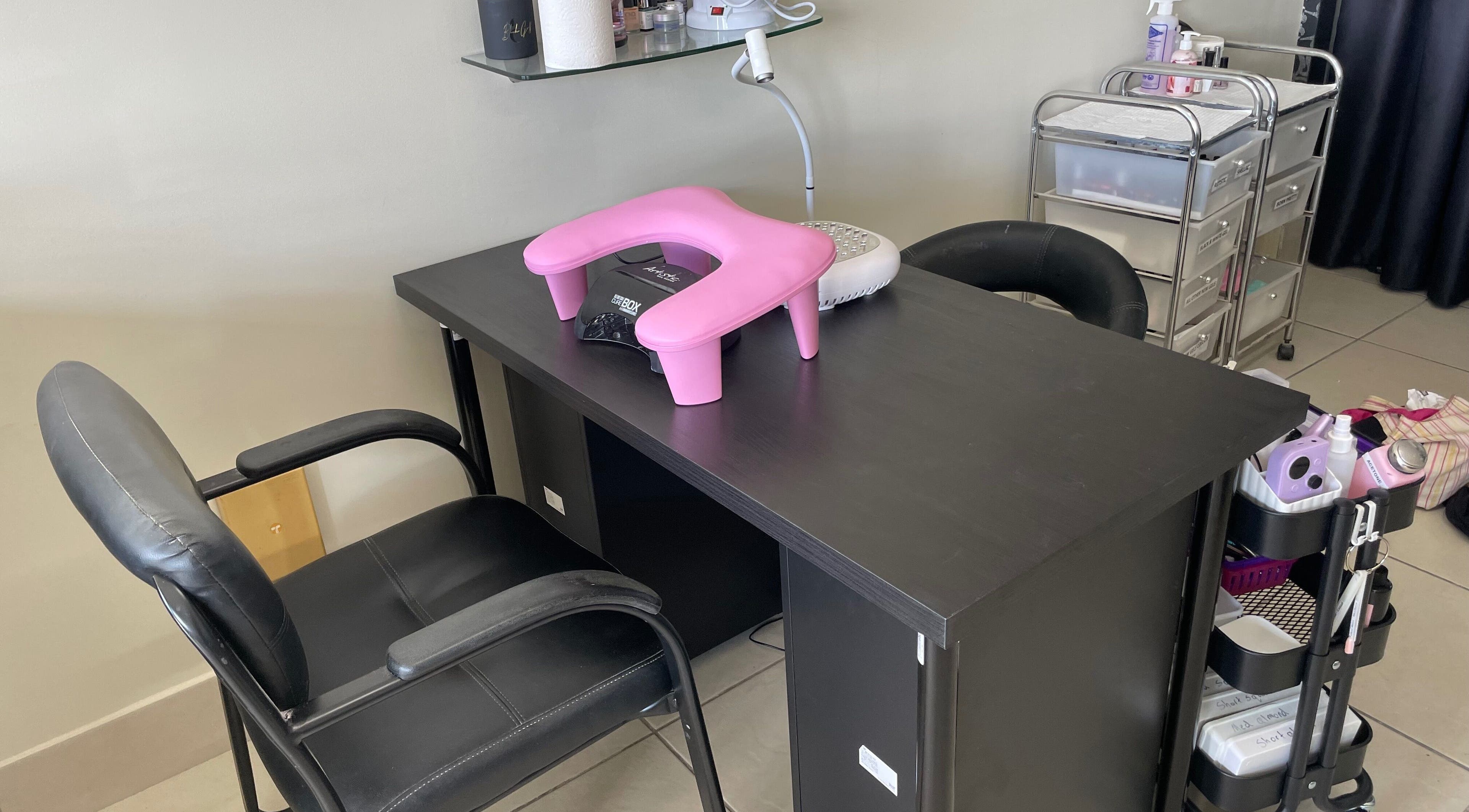 Candied Clawz nail workstation with pink cushion and manicure tools in Ashmore, Queensland, AU.