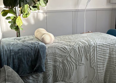 Peaceful spa bed in Glee Lash, Koongamia, Western Australia, AU, with green plant and textured blanket.