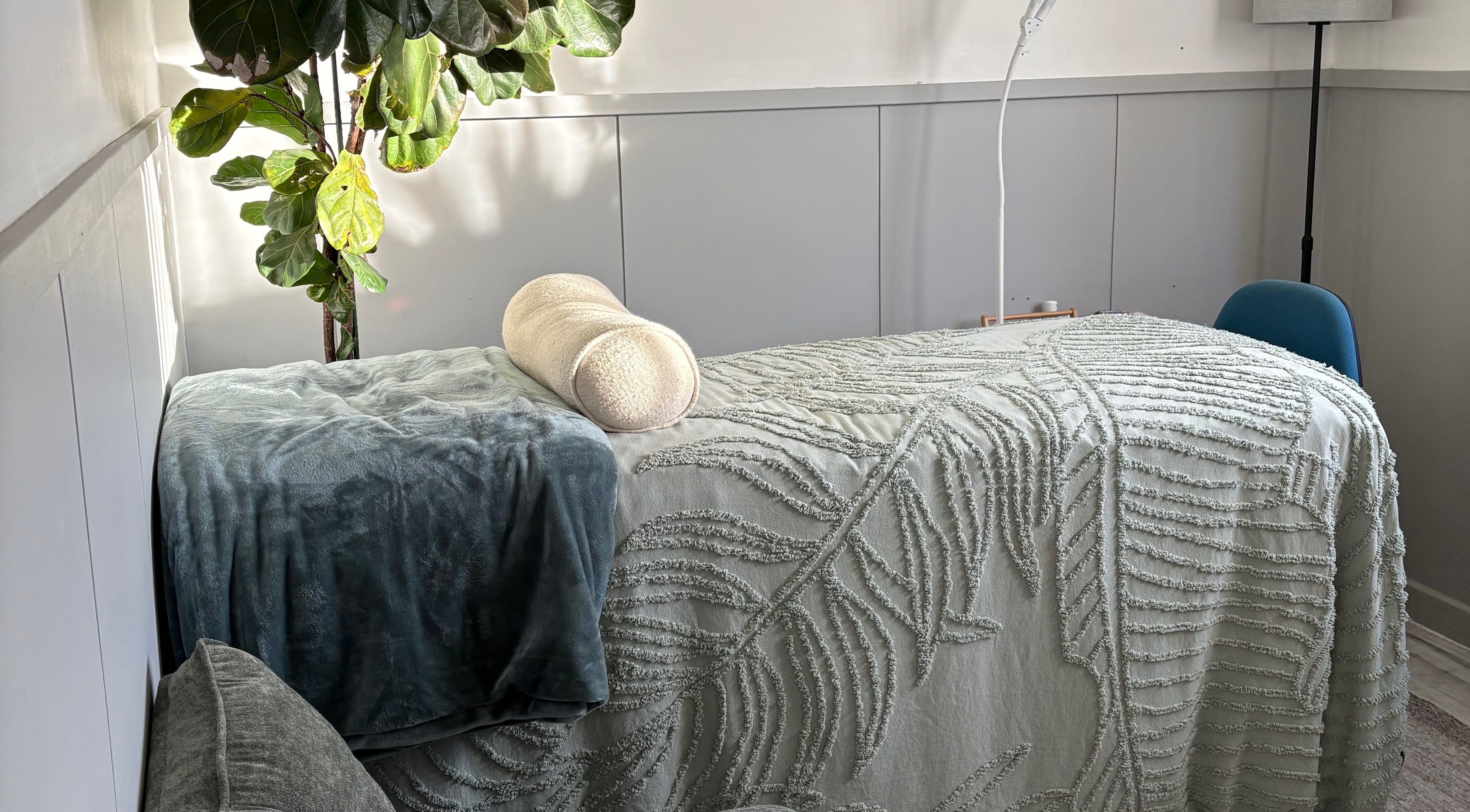 Peaceful spa bed in Glee Lash, Koongamia, Western Australia, AU, with green plant and textured blanket.