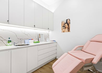 Lueur Clinic treatment room in North Willoughby, New South Wales, AU with pink chair and modern decor.