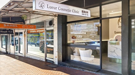 Entrance of Lueur Clinic in North Willoughby, New South Wales, AU showcasing its modern glass exterior.