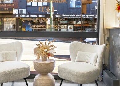 Chic seating area at Lueur Clinic in North Willoughby, New South Wales, AU with stylish chairs and floral decor.