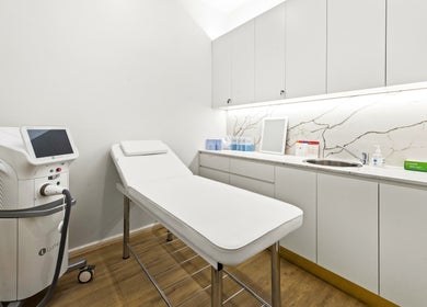 Modern treatment room at Lueur Clinic, North Willoughby, New South Wales, AU with sleek cabinetry and equipment.